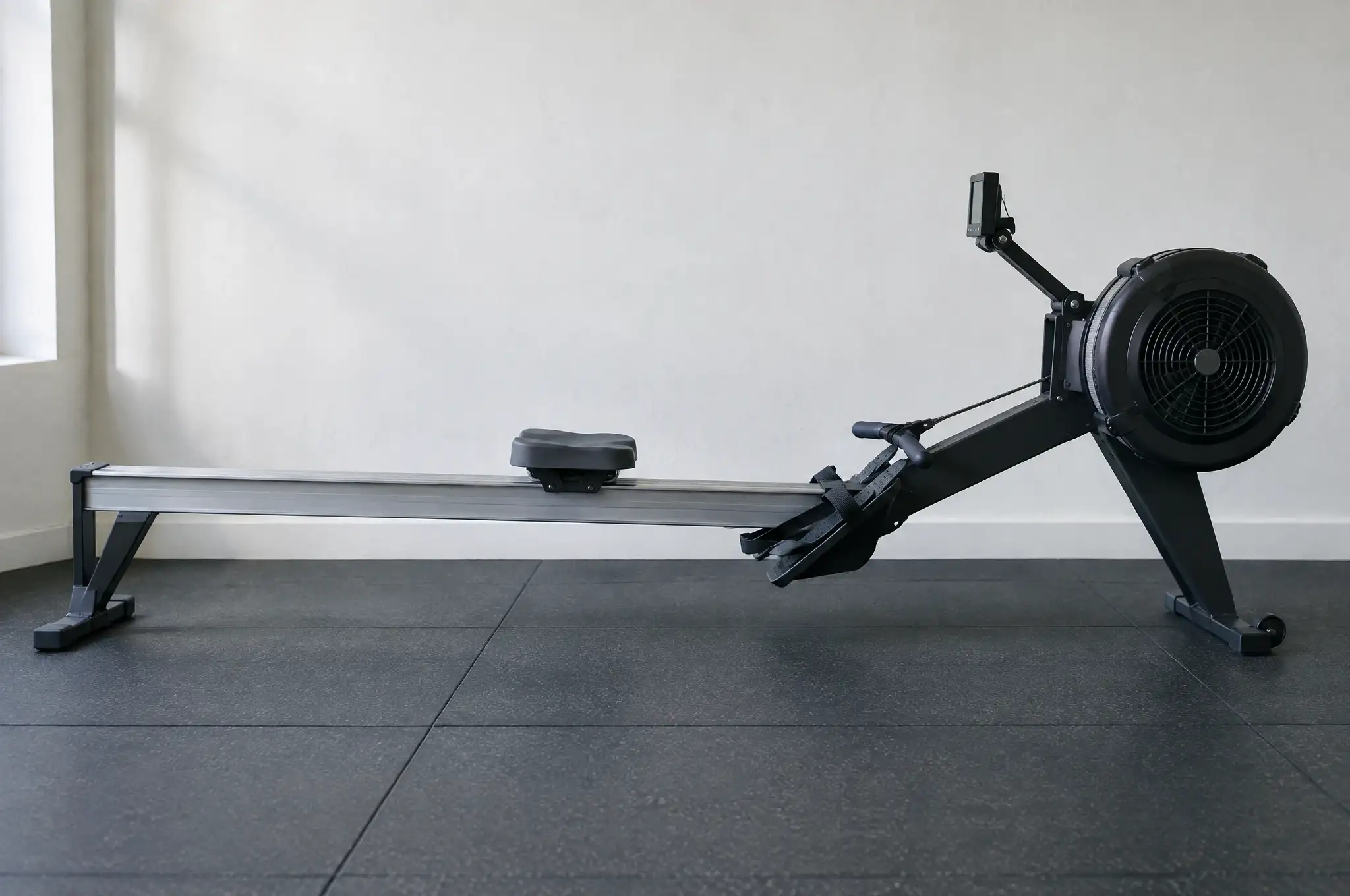 An air rowing machine along a white wall
